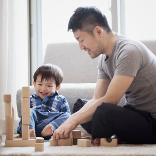 A father and son playing with blocks at Columbia Colony in Patuxent River, Maryland