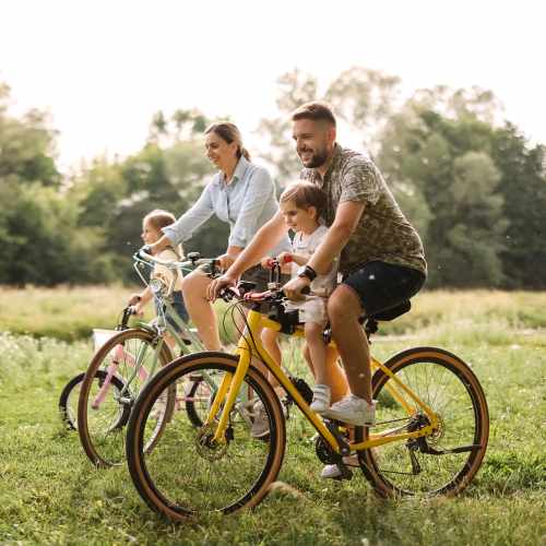 Couple with their children riding on bicycle at San Diego, California near Cresta Bella
