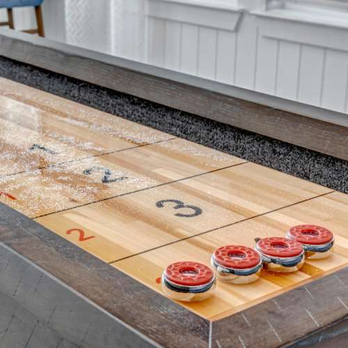 Shuffleboard table with game setup at The Carlton At Lake Dexter in Winter Haven, Florida