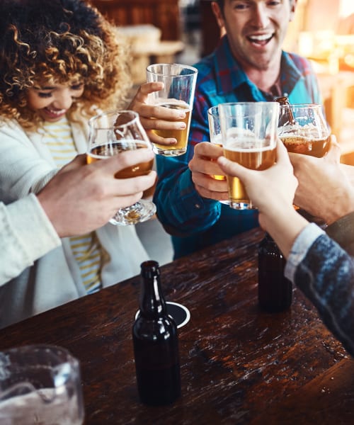 Friends having beers at a lively pub near Muirwood in Farmington Hills, Michigan