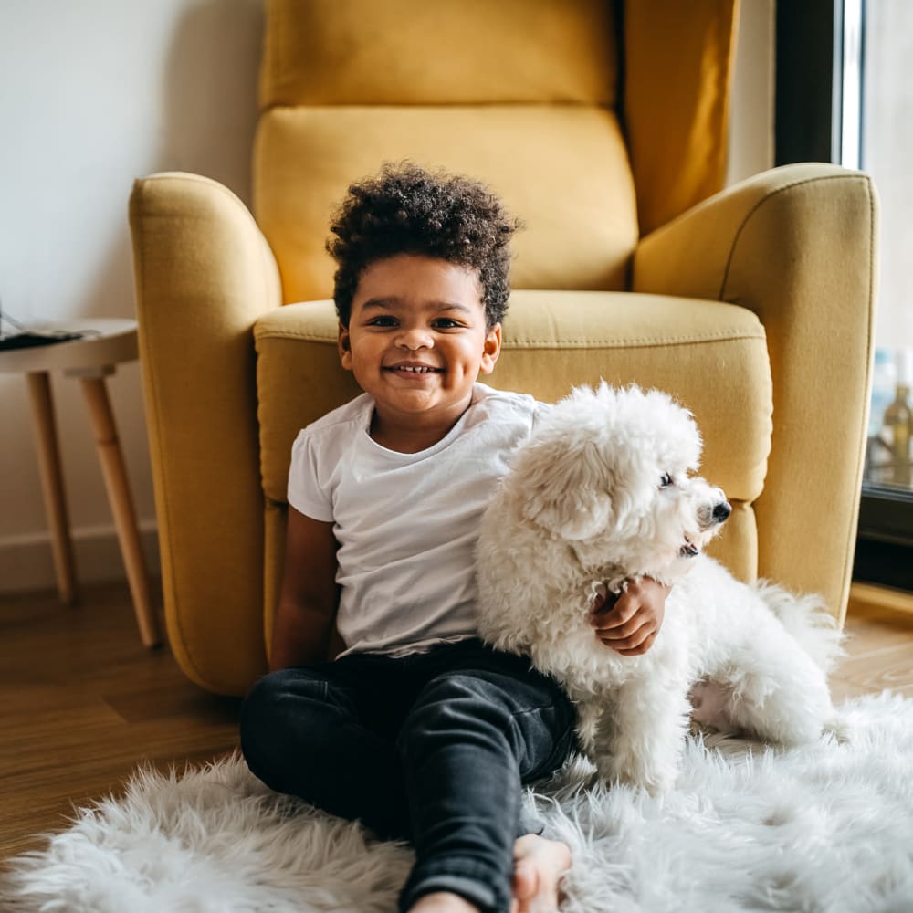 Child and his dog in their new home at our Oak Tree community at Mission Rock at Sonoma in Sonoma, California