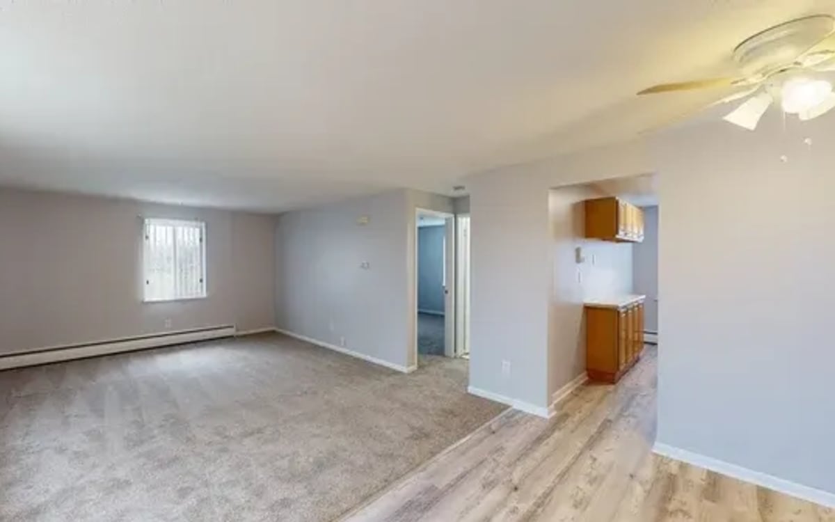 Living room with natural lighting at Highland Bay Apartments in Rochester, New York