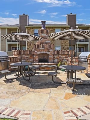 the Outdoor fireplace with benches at Cimarron Trails Apartments in Norman, Oklahoma