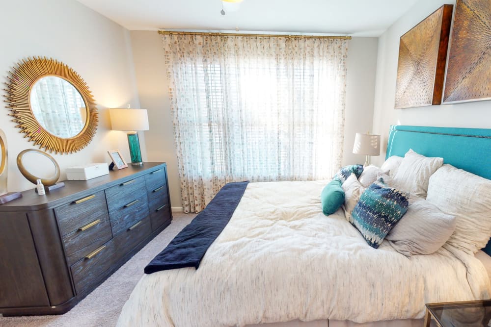 Plush carpeting and a ceiling fan in a model home's bedroom at The Palmer in Charlotte, North Carolina