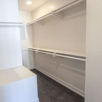 A large walk-in closet at River Place in Lakeside, California