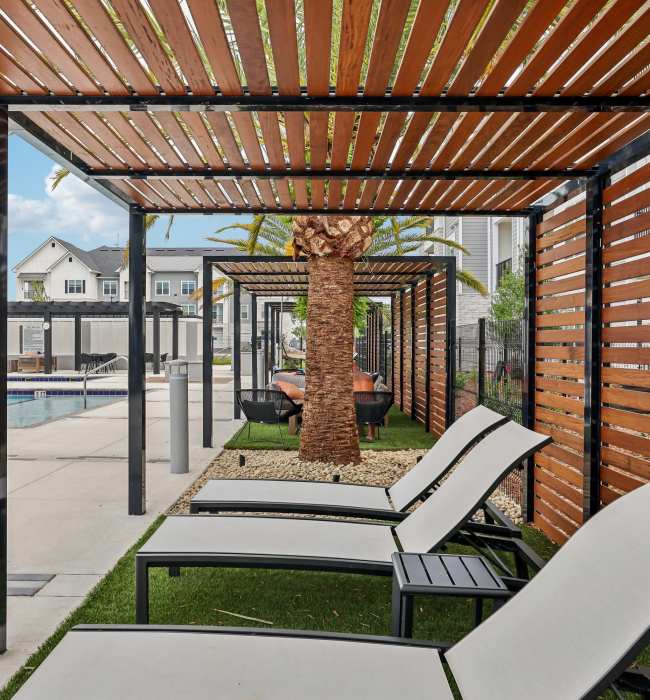 Covered outside seating near the swimming pool at The Southerly at Orange City in Orange City, Florida