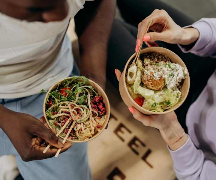 Couple having salad and noodles at Milan in Austin, Texas