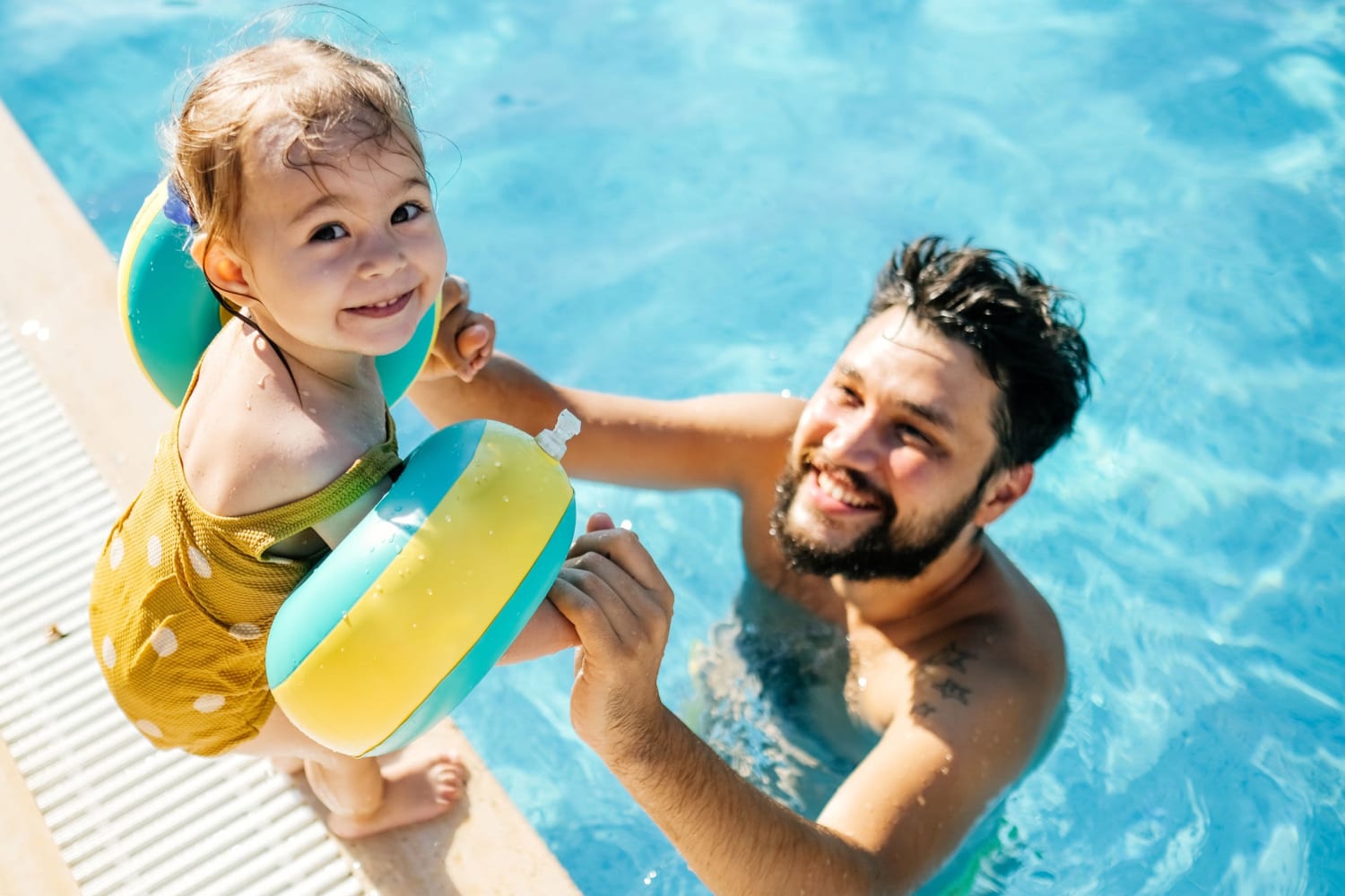 A resident and child in the pool at Village on Hill Street in Raleigh, North Carolina