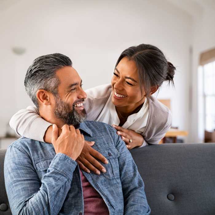 A happy couple hug in their apartment at Commons on Potomac Square, Sterling, Virginia