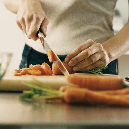 Chopping carrots in a kitchen at Mission University Pines in Durham, North Carolina