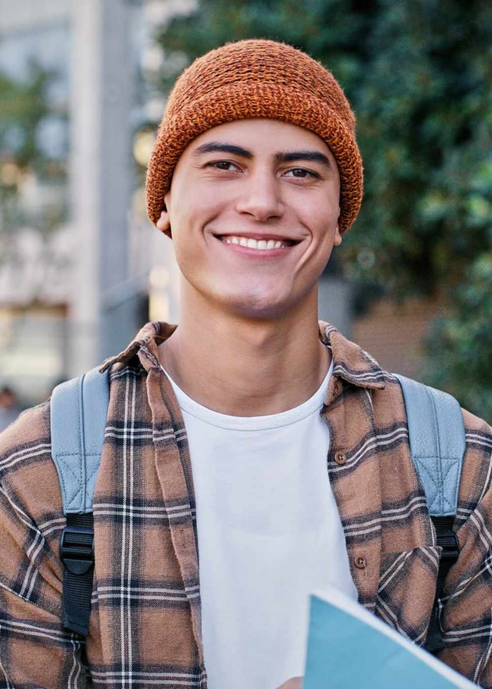 A resident student carrying a binder near Terrene at the Grove in Wilsonville, Oregon 