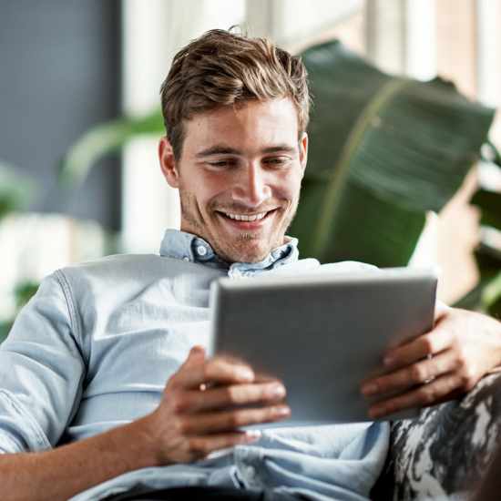 A man using tablet at Hawks Prairie Apartments in Lacey, Washington