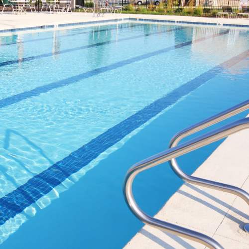 Poolside railing and clear water at Avia Lofts at Maple Road in Amherst, New York