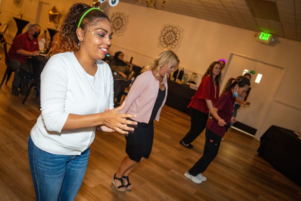 Employees having fun on the dance floor at Ray Stone Inc.