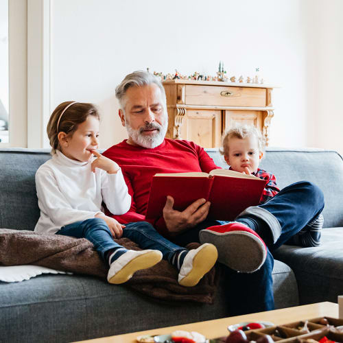 Resident reading with his grandchildren at 2800 McFarland in Tuscaloosa, Alabama