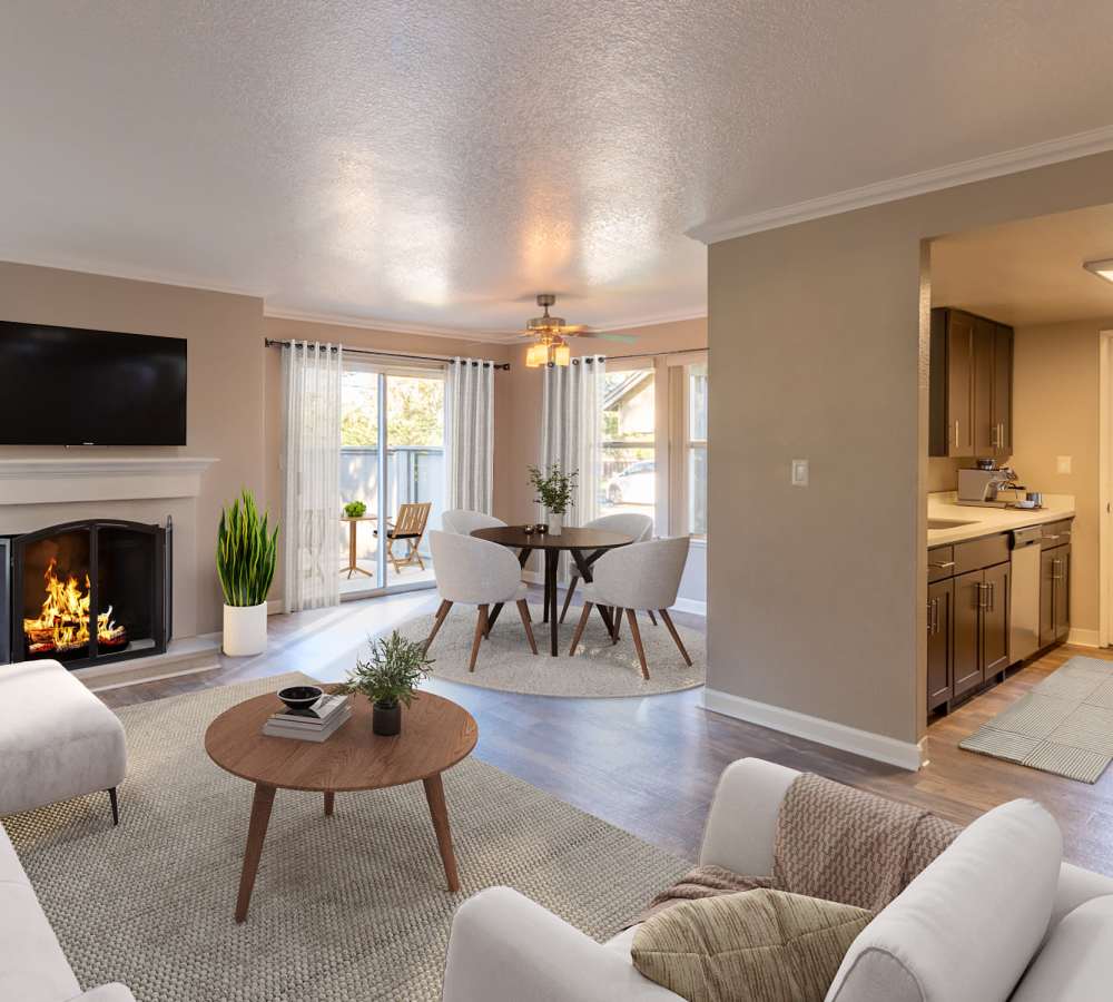 Living room and kitchen with natural light at Seventeen Mile Drive Village Apartment Homes in Pacific Grove, California
