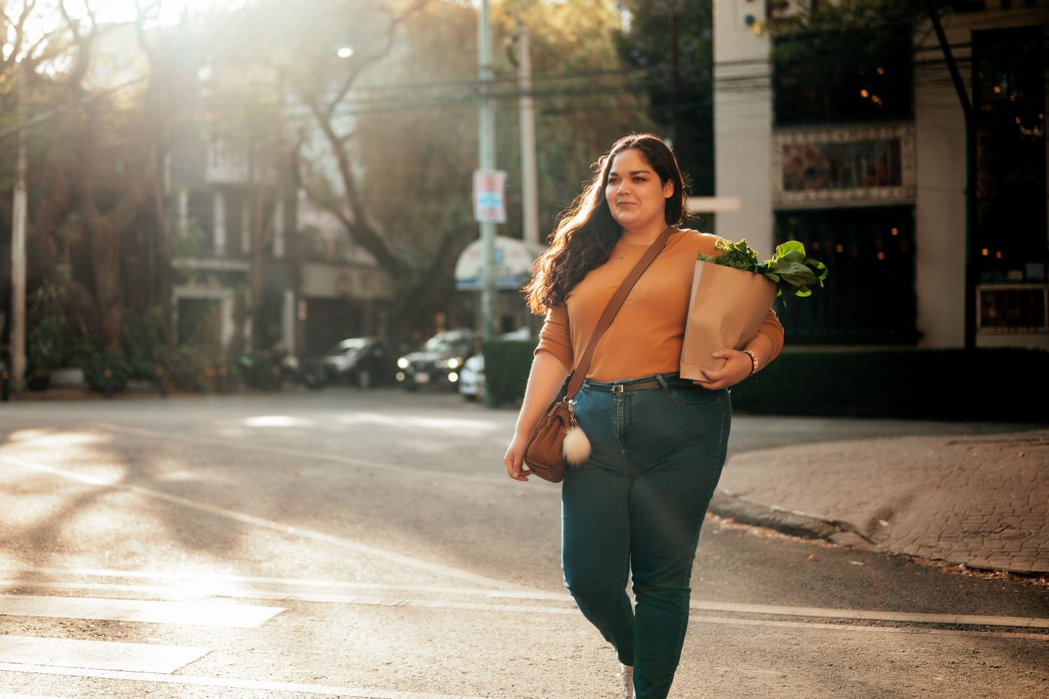 A woman carrying a bag of groceries near Georgetowne Woods in Gastonia, North Carolina