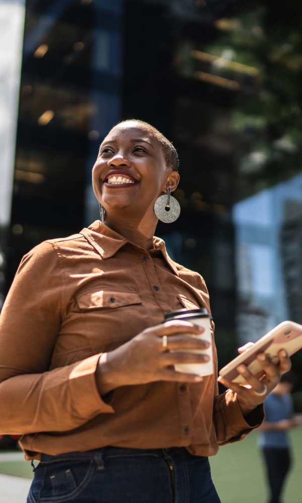 Resident holding a coffee while exploring the city near The Abbey at Inverness in Birmingham, Alabama
