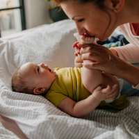 Mother playing with her baby at ARTISAN Management Group in Des Moines, 