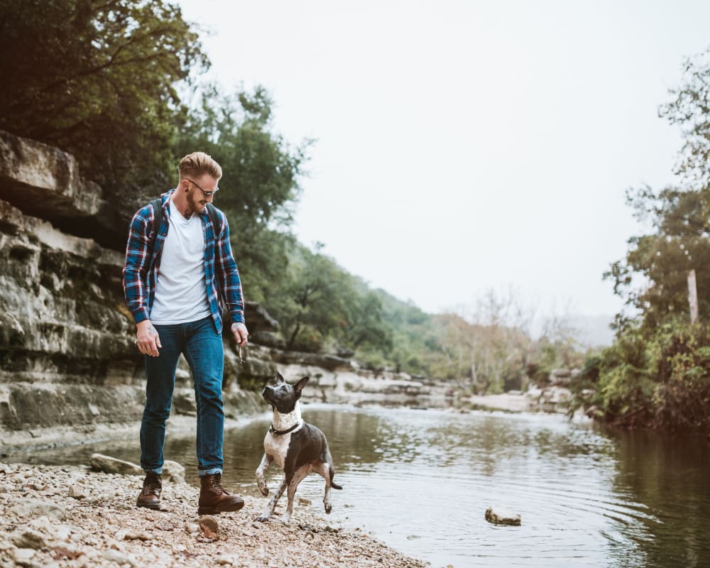 Resident out adventuring with his dog at a river near Opal at Barker Cypress in Houston, Texas