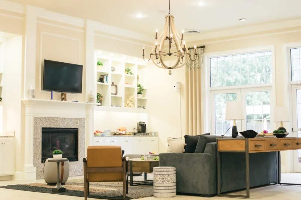 A spacious clubhouse with a fireplace and comfortable seating at Denbigh Village in Newport News, Virginia