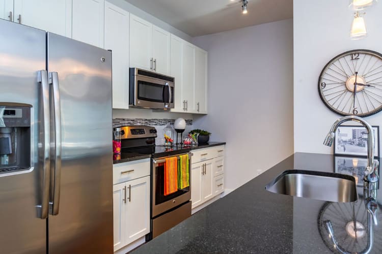 Kitchen with stainless steel appliances and granite style countertops at Central Station on Orange in Orlando, Florida