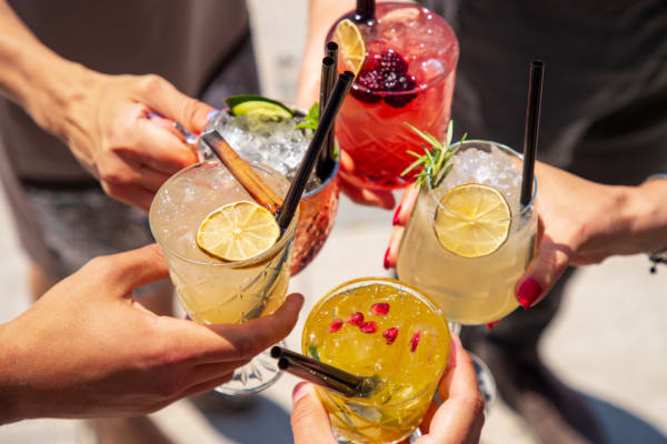 Friends all saying cheers with the colorful drinks near BB Living Harvest in Argyle, Texas