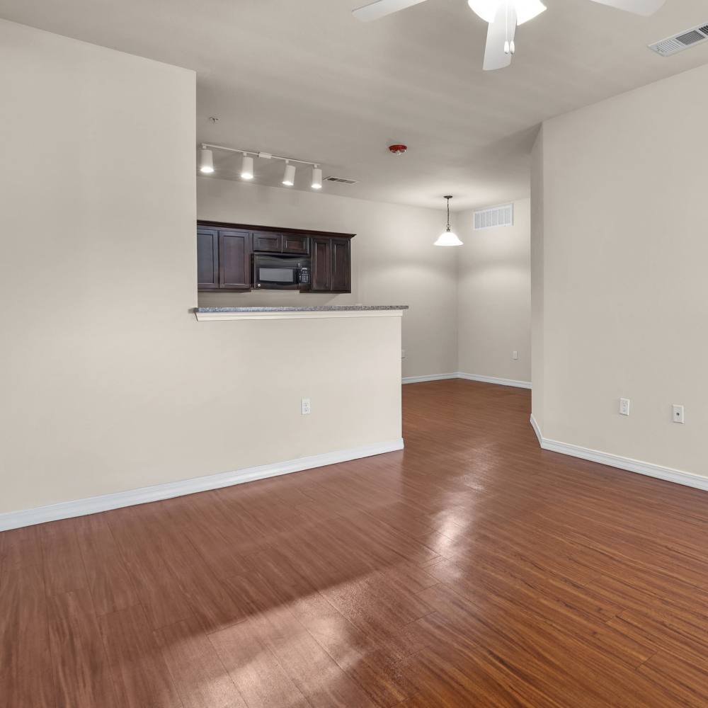 Living room with wooden flooring at Las Torres Apartments in El Paso, Texas