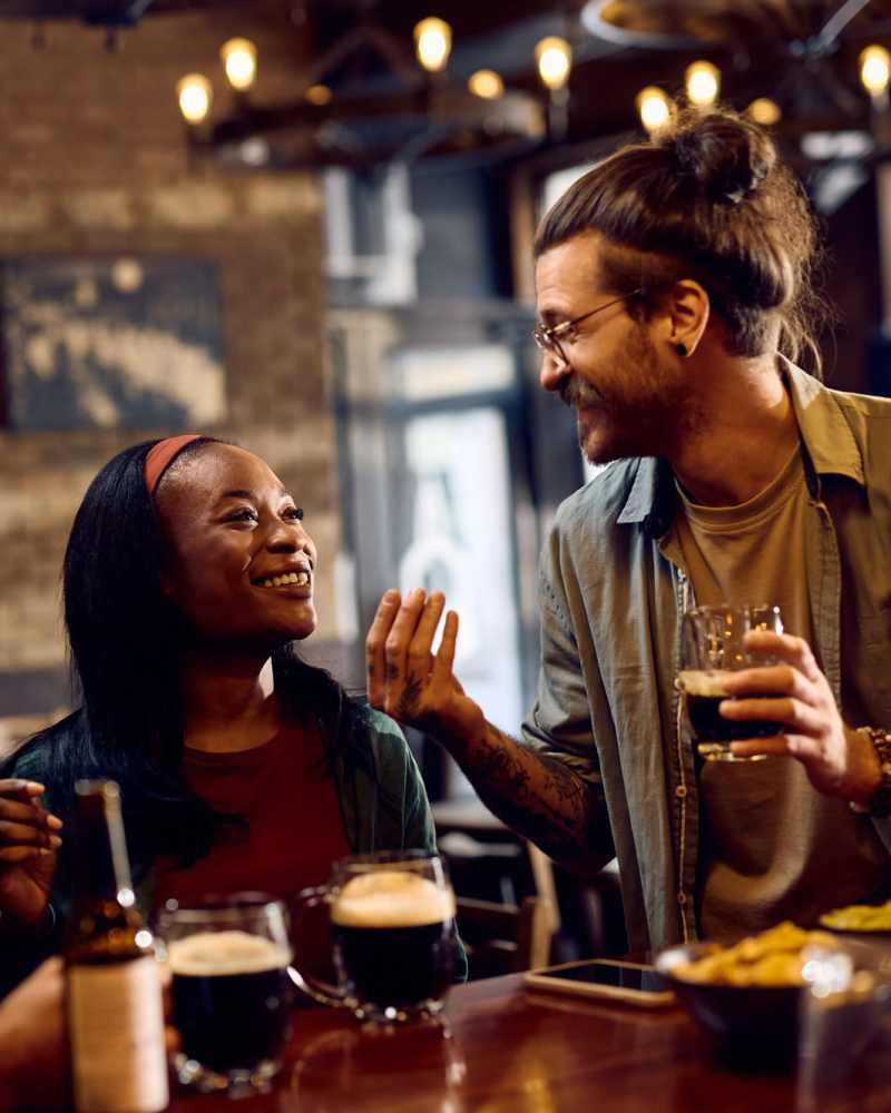 Residents with drinks in a restaurant near Vivo Living Kissimmee in Kissimmee, Florida