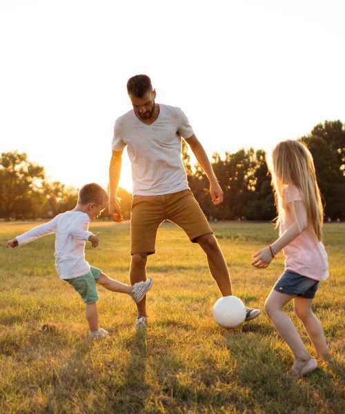 Resident playing with kids at park near Greentree in Indianapolis, Indiana