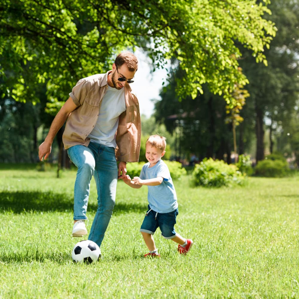 Resident father and son playing soccer in a park near Sun Housing in Shuqualak, Mississippi