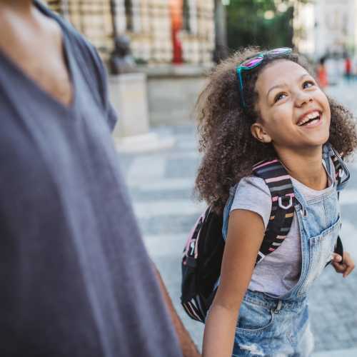 Kid happily going to the school wearing bag near Emerald Palms in Miami, Florida