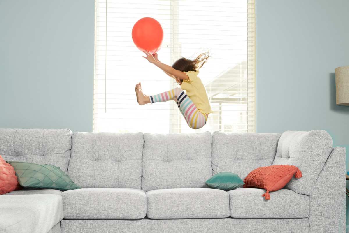 A child jumping on a couch at BB Living Desert Ridge in Phoenix, Arizona