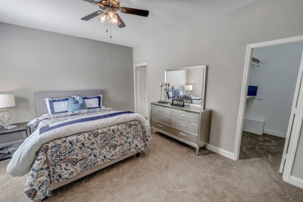 Plush carpeting and a ceiling fan in an apartment bedroom at Brighton Park in Byron, Georgia