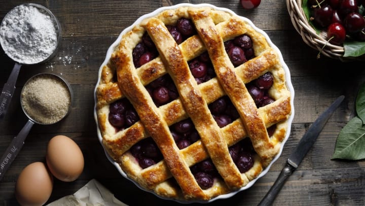 Homemade cherry pie with ingredients surrounding it on rustic table | pie near Peoria