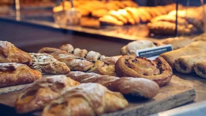different breads and pastries displayed in a glass display counter at a pastry shop | pastry shops near Phoenix