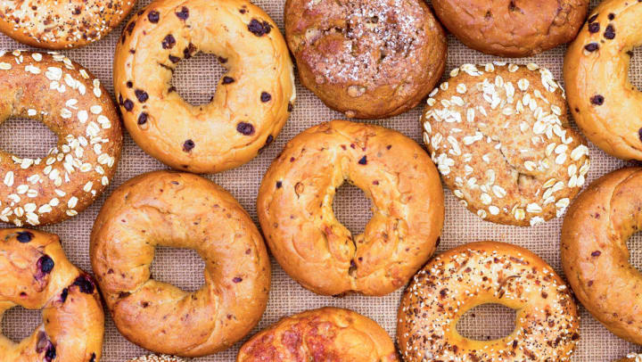 Top view of assorted variety of bagels on burlap background | Bagels in Jacksonville