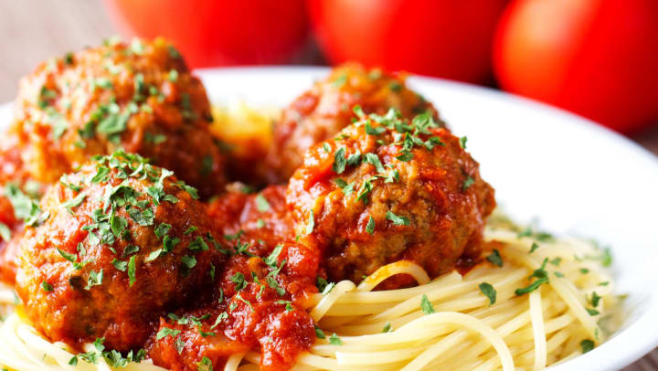 Close up of a plate of spaghetti and meatballs on a white plate | Italian Restaurants in Fort Worth