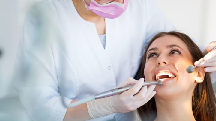 dentist doing a check up on her patient