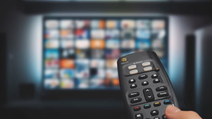 Person holding a remote control at Olympus Grand Crossing in Katy, Texas