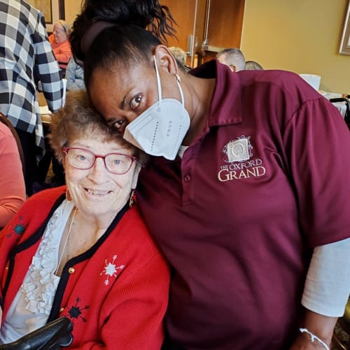 Happy masked caretaker at The Oxford Grand Assisted Living & Memory Care in Wichita, Kansas