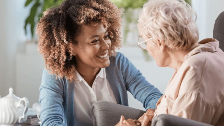 Caregiver having a conversation with elderly patient