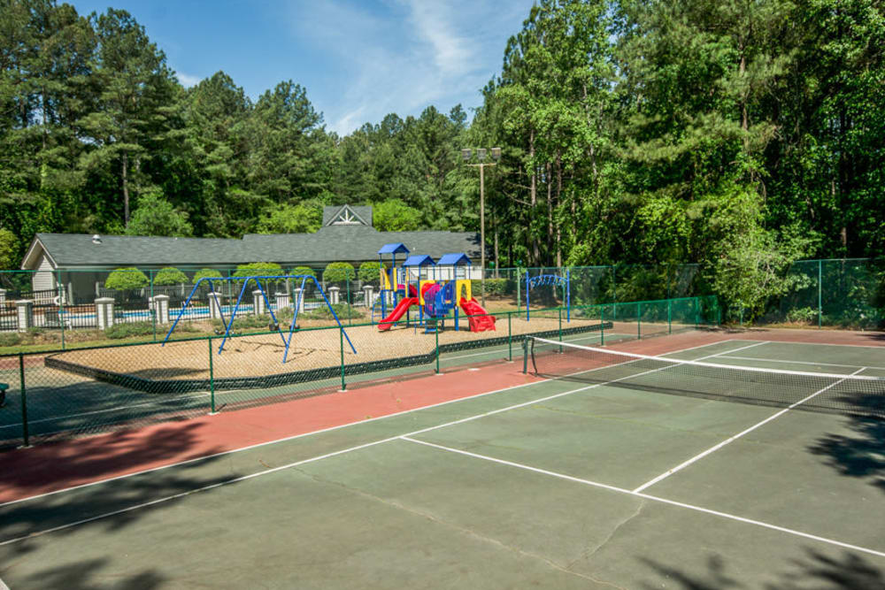 Tennis court next to the children's playground at Arbor Crossing Apartments in Lithonia, Georgia