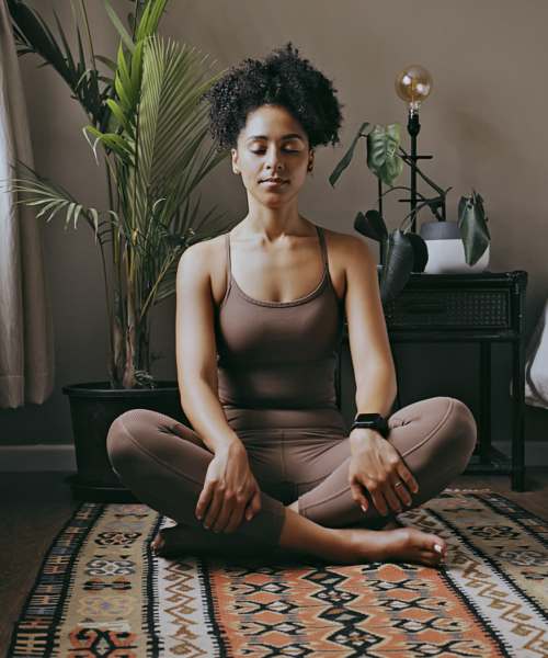 Residnet doing meditation in her living room at Village at First in Gilroy, California