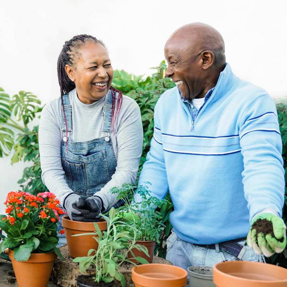 Happy senior residents gardening at home at Jasper Manor Apartments in Jasper, Texas