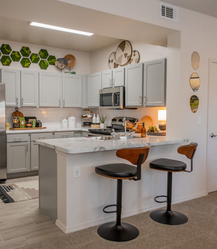 Kitchen and kitchen bar seating at 24Hundred Apartments in Oklahoma City, Oklahoma