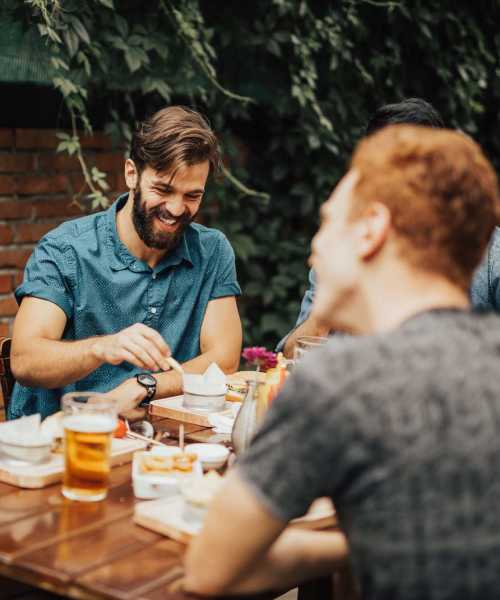 Friends having meals out in the sun at Earle Residences in Chicago, Illinois