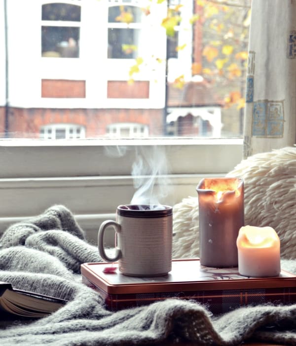 A nice warm cup of coffee with some candles for a calming evening at Eagle Rock Apartments at Maplewood in Maplewood, New Jersey