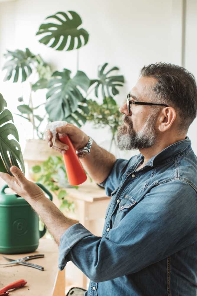 Man watering his plants at Monamos Terrace Apartments in Murrieta, California