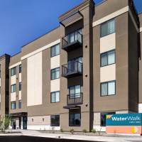 Modern apartment community exterior with balconies and main entrance at Waterwalk Tucson in Tucson, Arizona